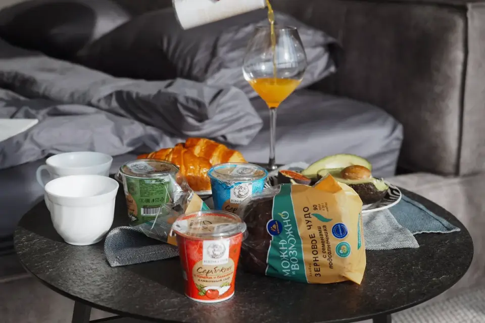 A dog eating from a travel bowl in a hotel room at a scheduled mealtime