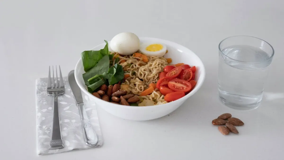 A sliced hard-boiled egg placed beside a stainless dog food bowl