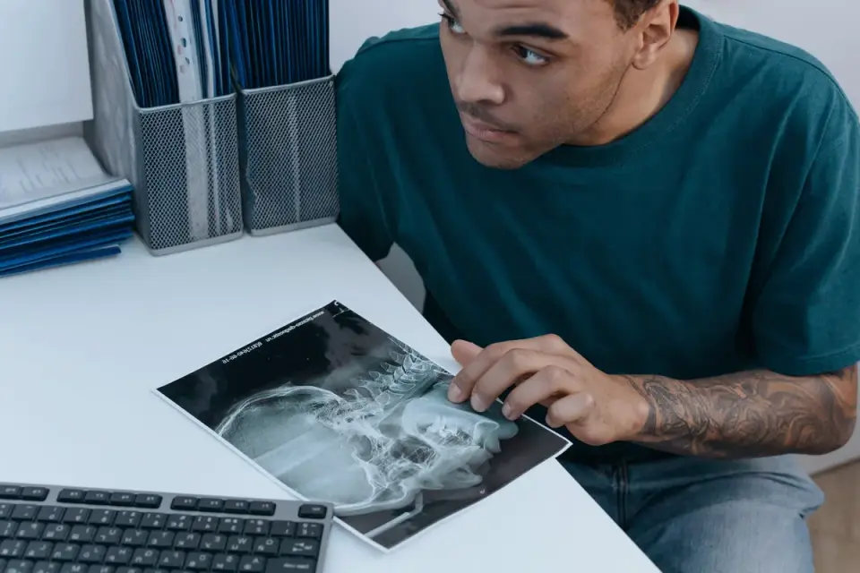 A veterinarian examining an abdominal x-ray on a lightbox