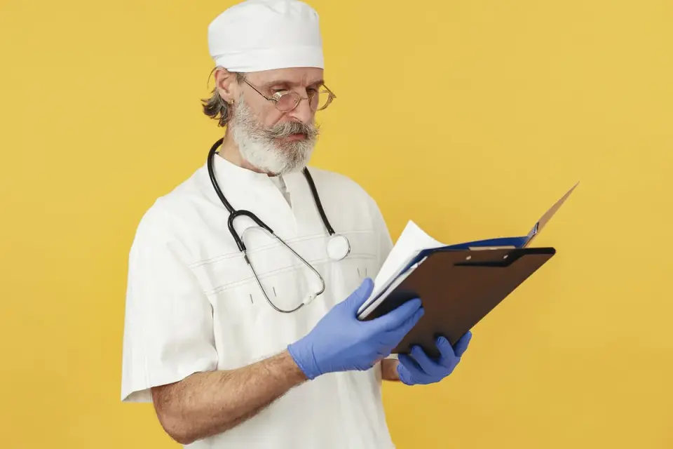 A veterinarian examining a supplement label beside a senior dog on an exam table