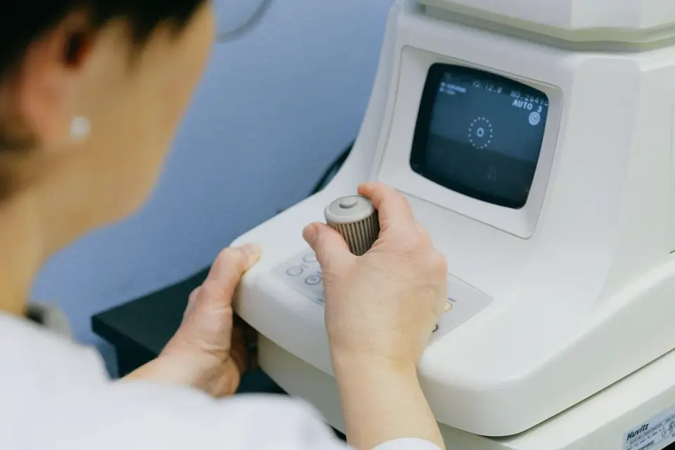 A veterinarian gently examining a gray-muzzled senior dog on an exam table
