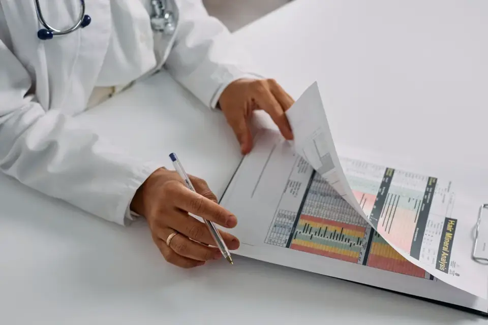 A veterinarian reviewing a nutrition worksheet with a dog owner at a clinic desk