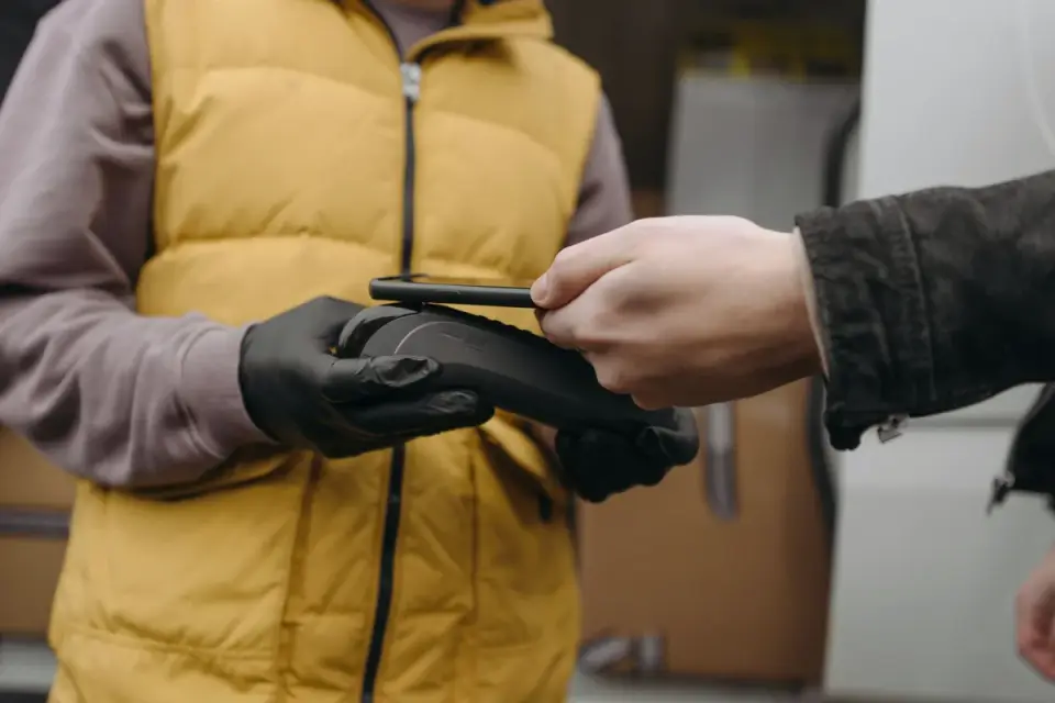 A veterinarian scanning a dog's shoulder area with a handheld microchip reader