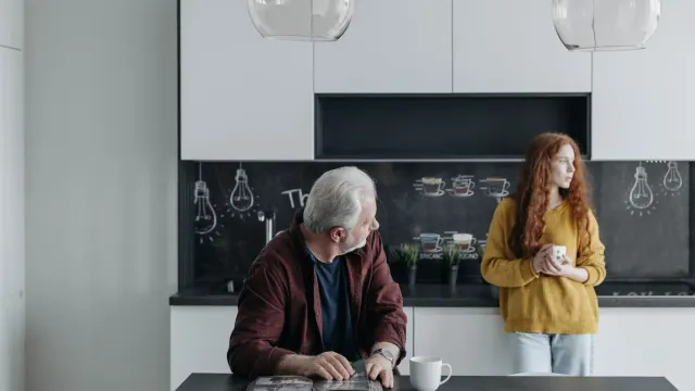 An owner comparing two dog supplement containers on a kitchen counter